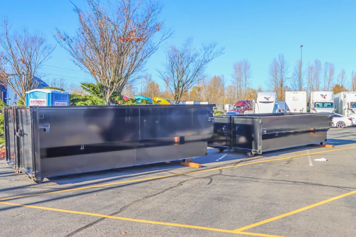 Professional dumpster rental service with roll-off container on residential driveway in Old Tappan